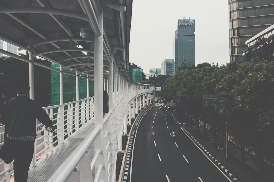 man walking on bridge