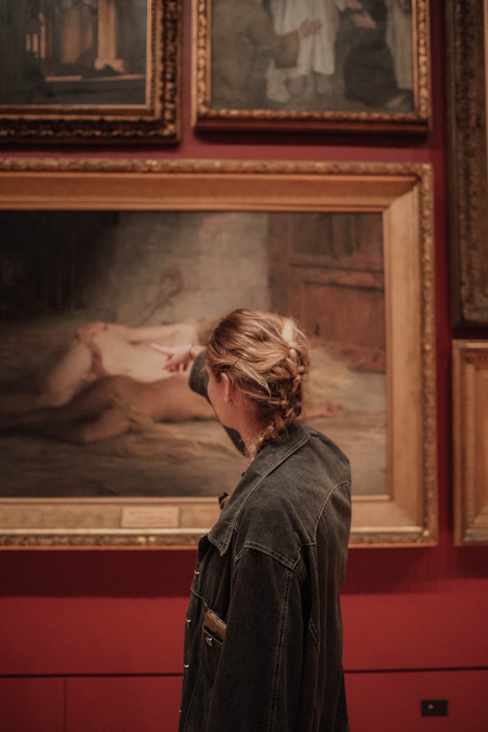 A person pointing at a painting