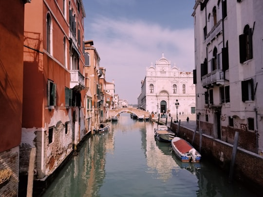 boat in canal between houses in Basilica dei Santi Giovanni e Paolo Italy