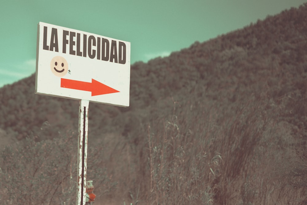 photo of white and black la felicidad signage