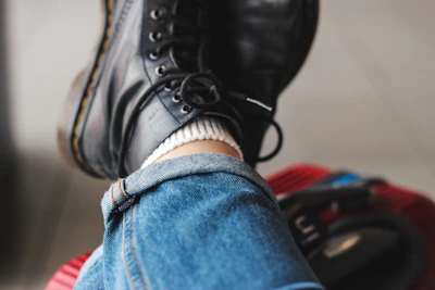 Close-up of stylish denim jeans folded neatly with a leather belt