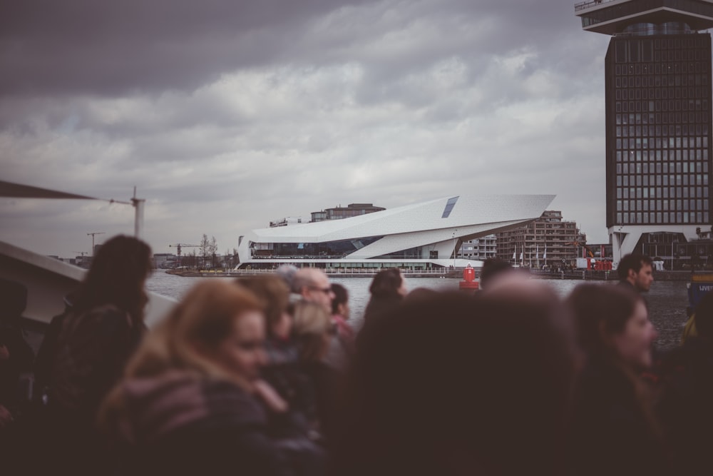 people gathering outside near buildings during daytime