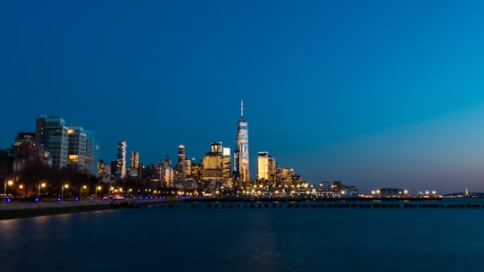 lighted concrete buildings front of sea at night time in Whitney Museum of American Art United States