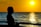 woman standing infront of beach during sunset