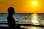 woman standing infront of beach during sunset