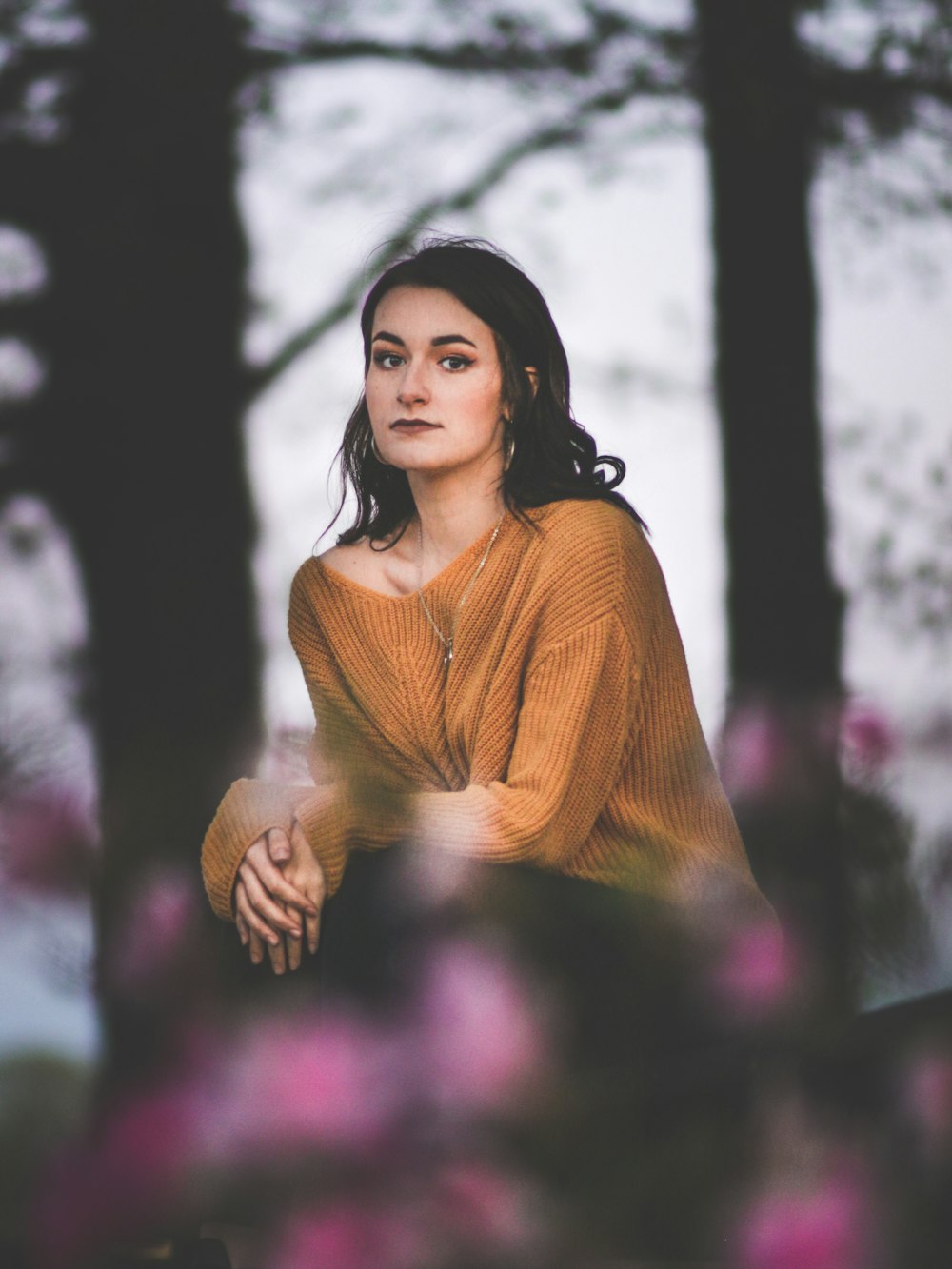 selective focus photograph of woman in brown shirt