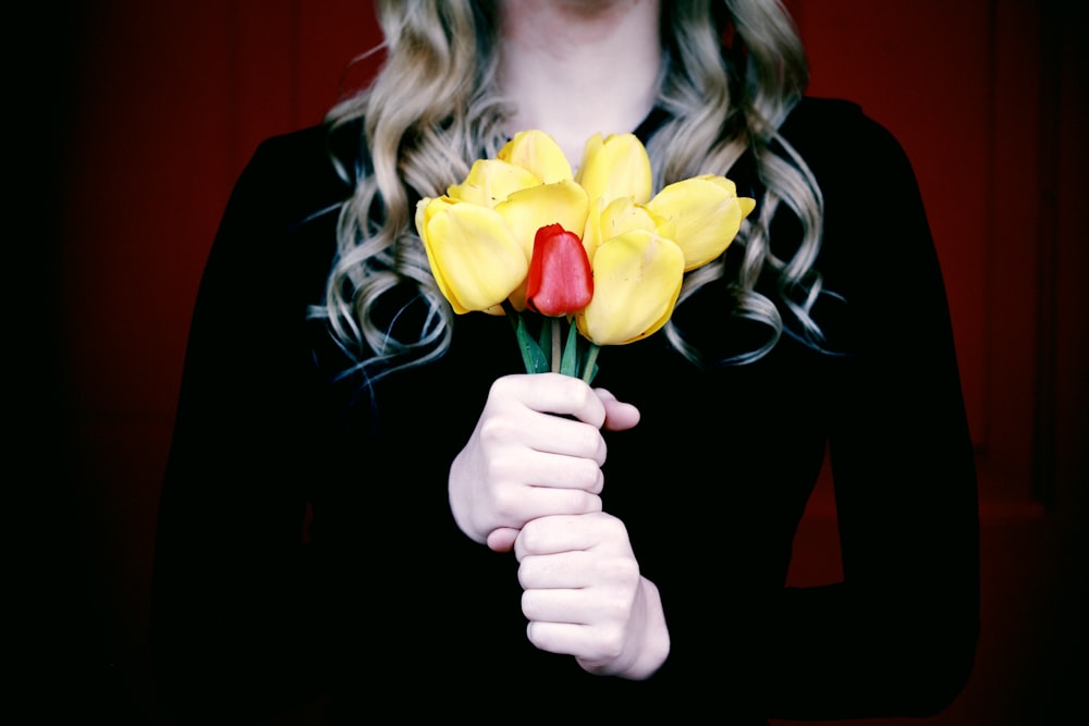 woman holding artificial flowers