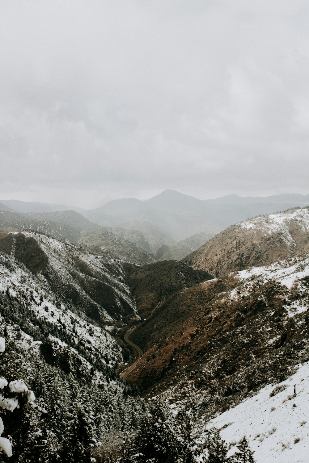 snow covered mountain under white clouds at daytime