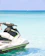 Close-up of a sleek jet ski covered with a matte black Aurumwave protective cover accented by gold stitching.