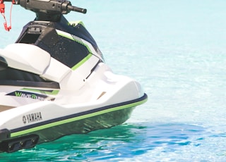 white and green personal watercraft on water