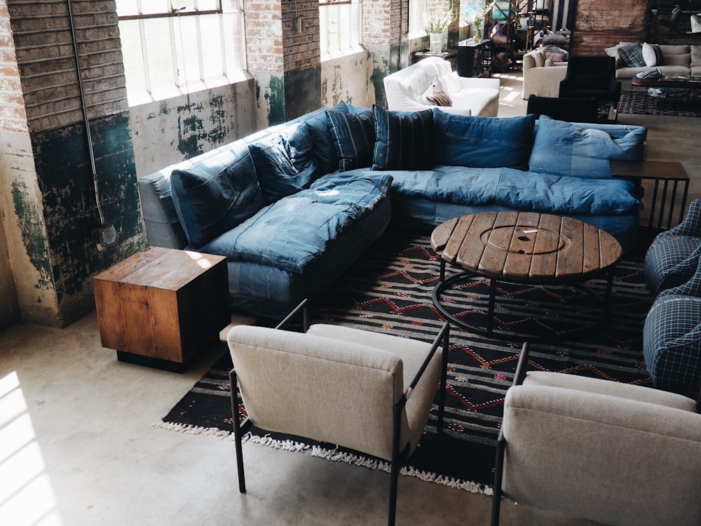 blue couch and white armchairs