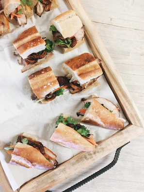 A tray of colorful mini sandwiches neatly stacked, ready for a party.