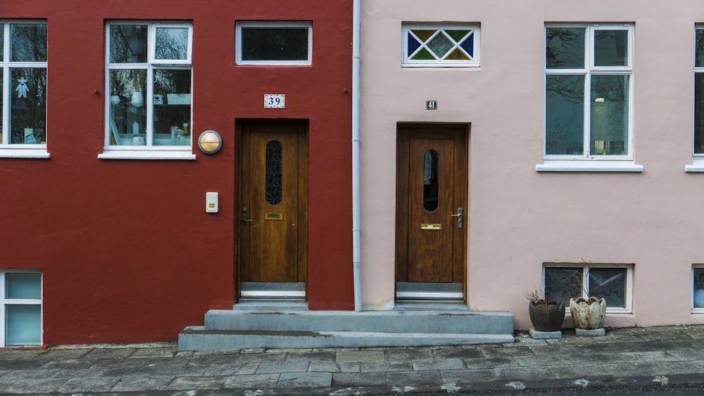 red and pink houses with brown wooden doors