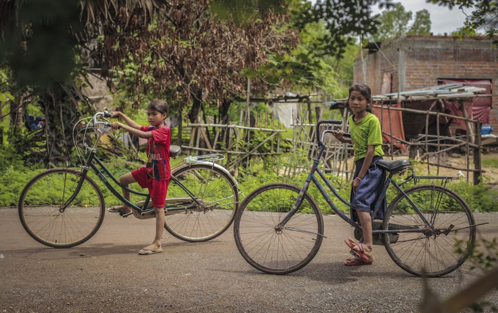 two girls riding on bicycles