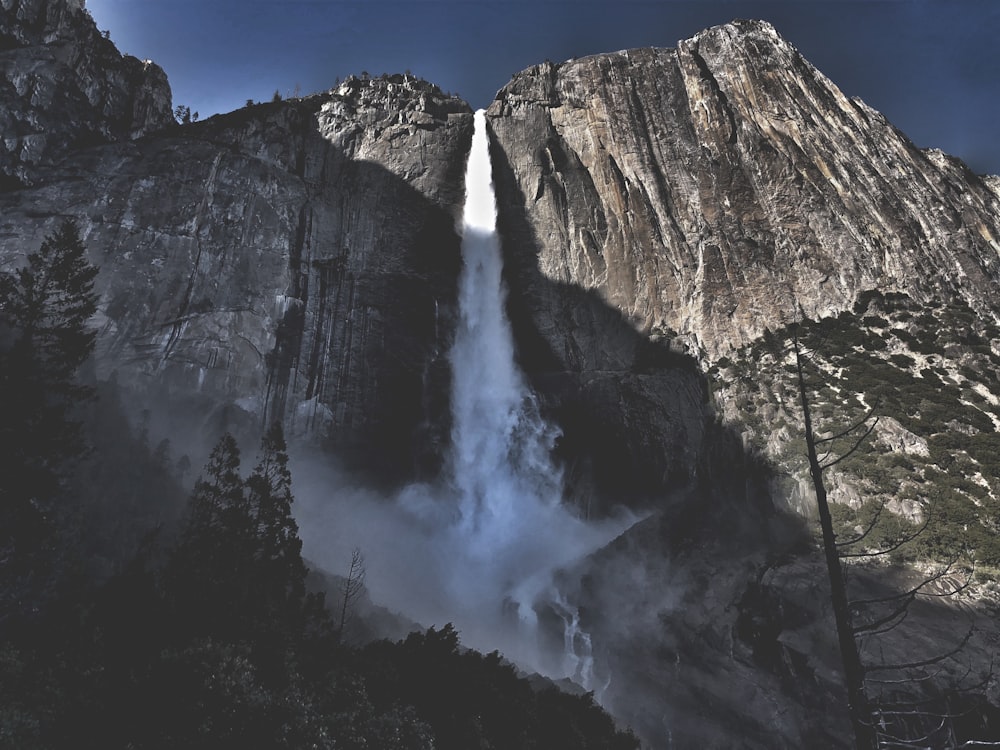 worm's-eye view of waterfalls under blue sky