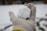Close-up of a hand wearing a soft wool blend glove against a snowy background.