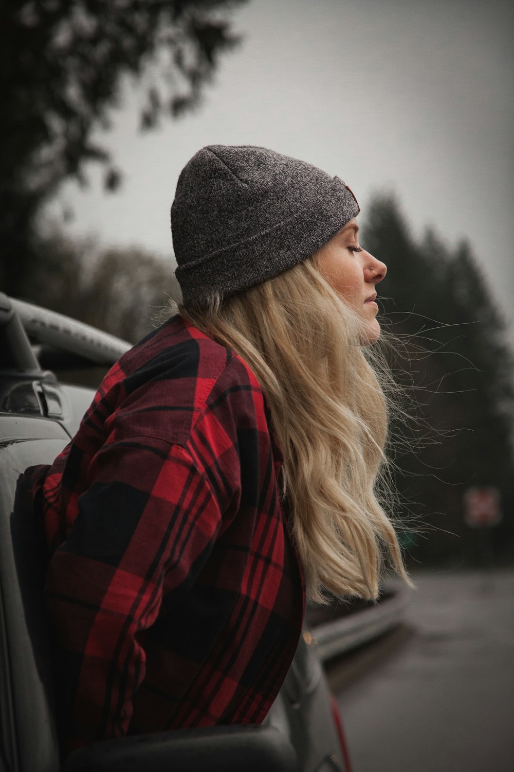 woman looking out vehicle window