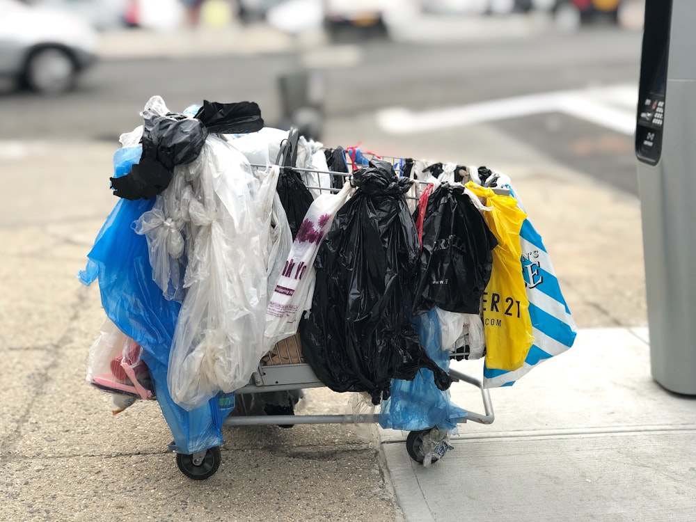 assorted=color plastic pack in shopping cart on street