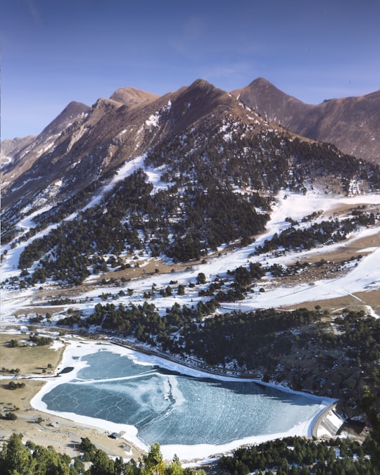 body of water beside trees near mountain in Vall de Núria Spain