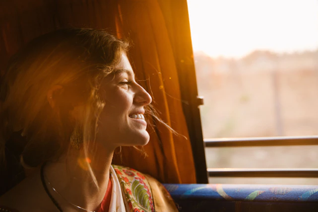 A calm woman sitting peacefully by a window with soft natural light, embodying tranquility and scientific wellness.