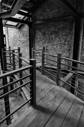 Wide shot of an industrial-style staircase combining metal railings and wooden steps in natural light.