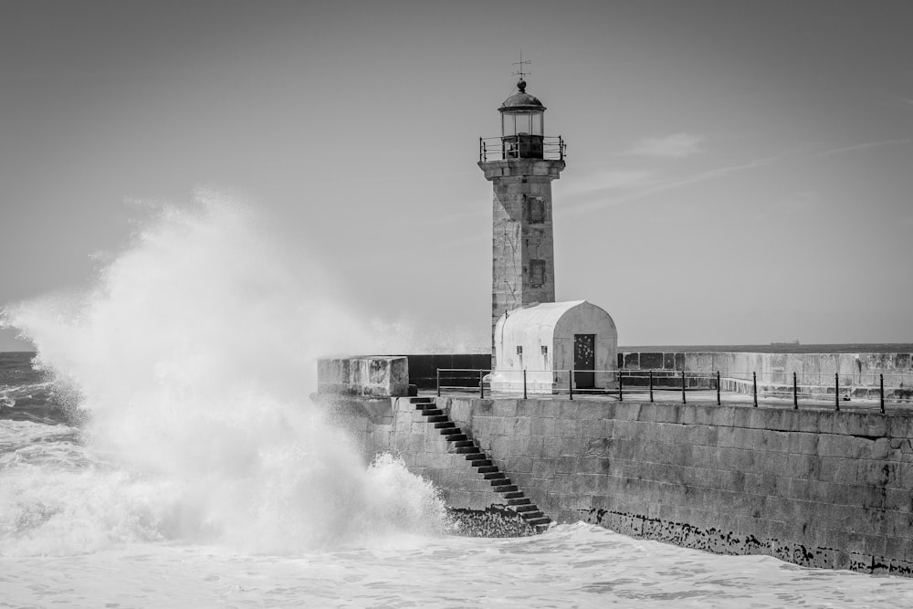 ocean waves beside gray concrete wall