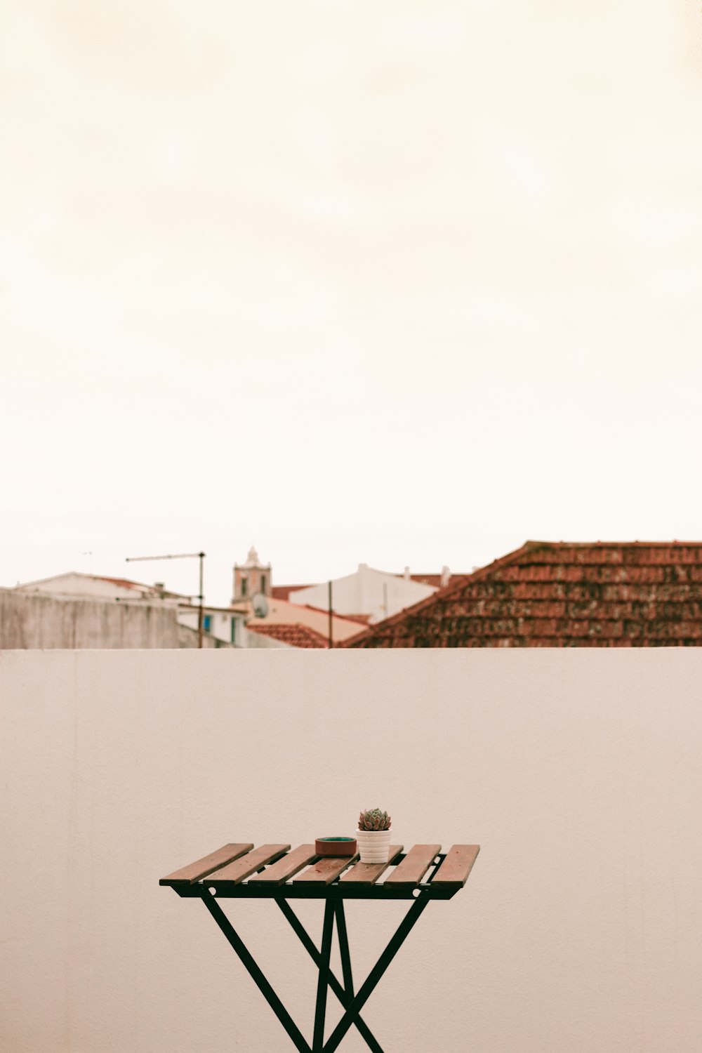 brown table beside white wall