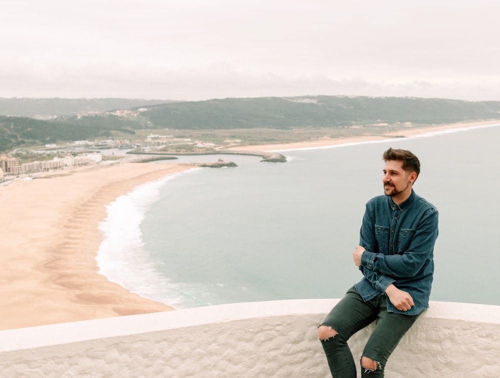 man sitting on bridge