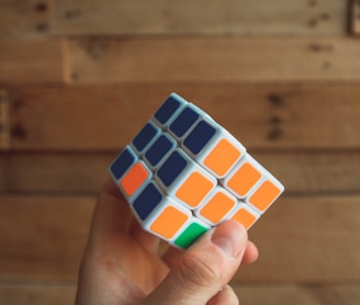 person holding 3x3 Rubik's Cube