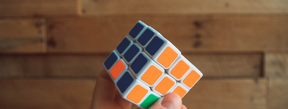 person holding 3x3 Rubik's Cube