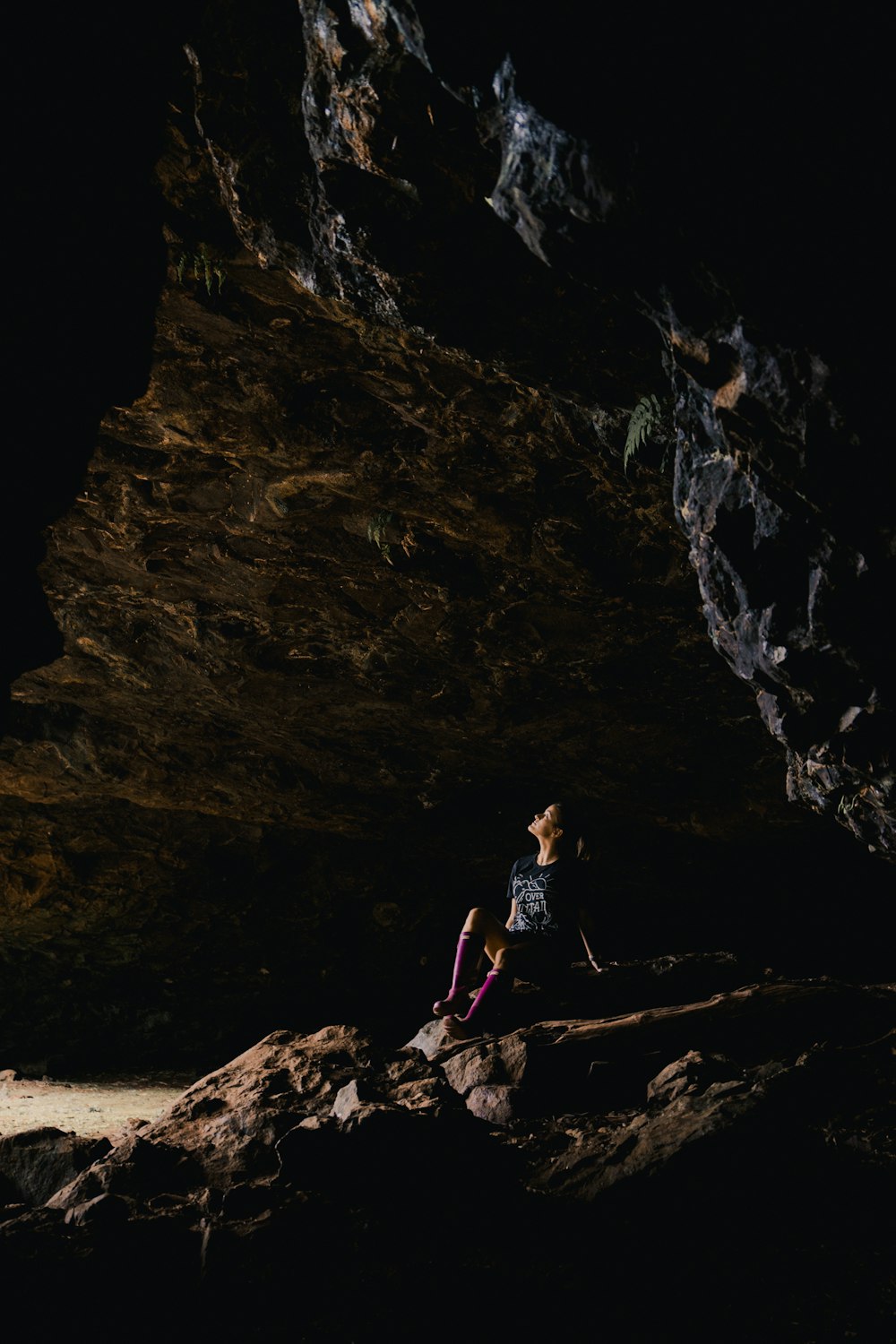 woman sitting inside cave