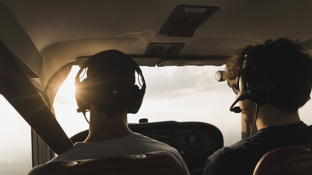 closeup photo of two pilot and co pilot inside plane