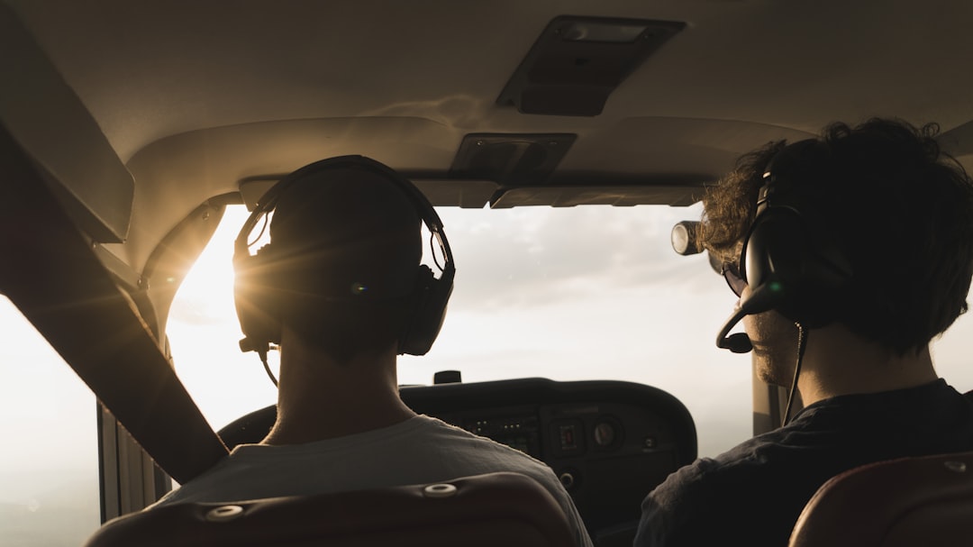 closeup photo of two pilot and co pilot inside plane, cockpitview