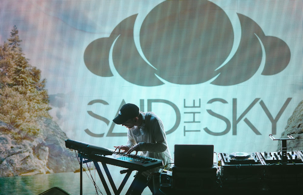 man playing electronic keyboard on stage