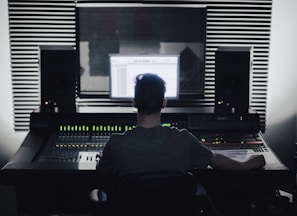 man sitting in front of computer setup