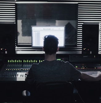 man sitting in front of computer setup