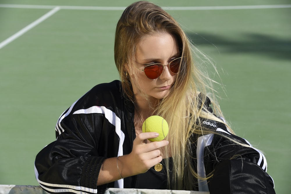 woman holding tennis ball