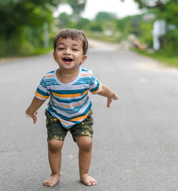 A joyful child wearing a colorful, comfortable outfit from minor modes, playing outdoors on a sunny day.