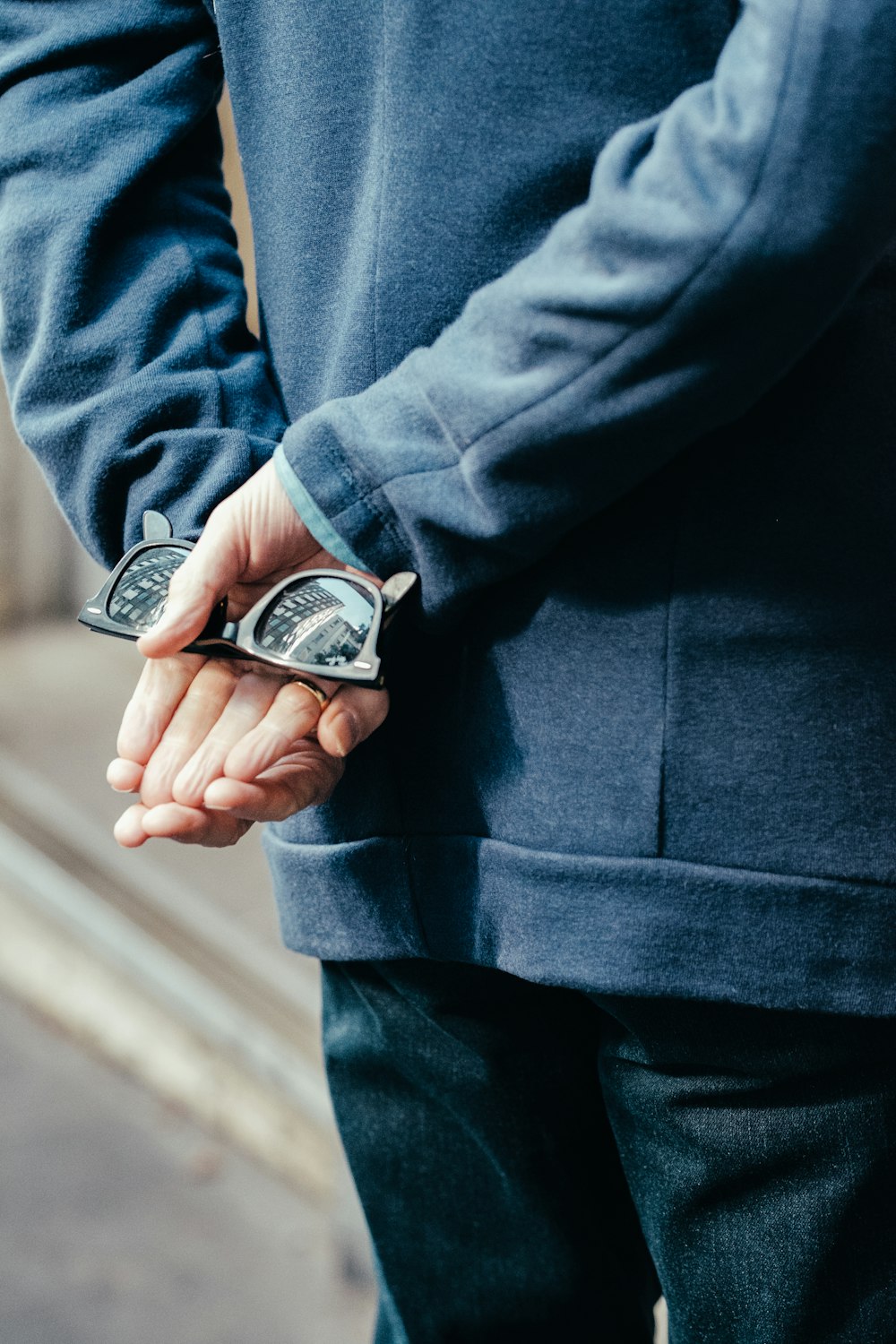 person holding black sunglasses