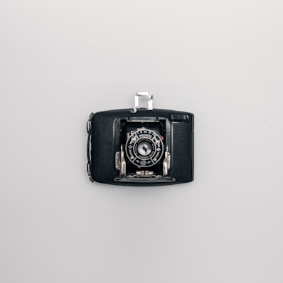 an old camera hanging on a wall