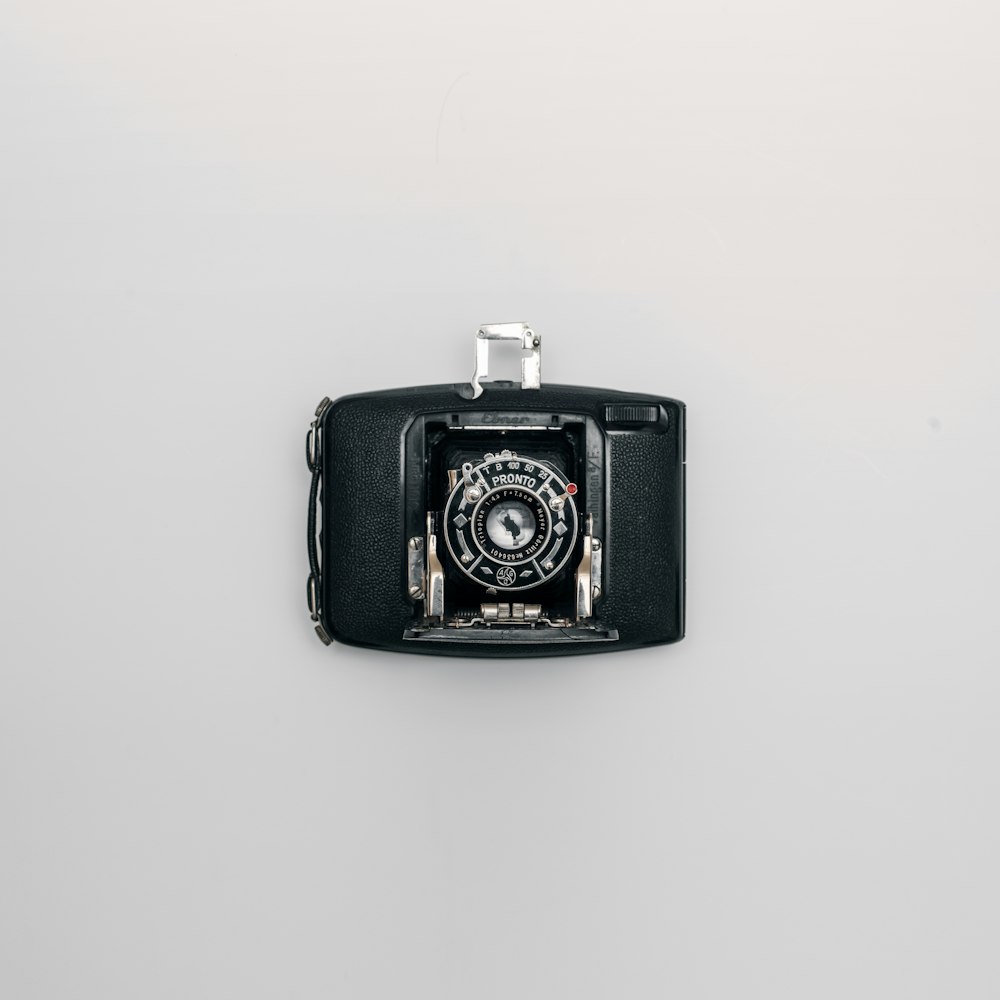 an old camera hanging on a wall