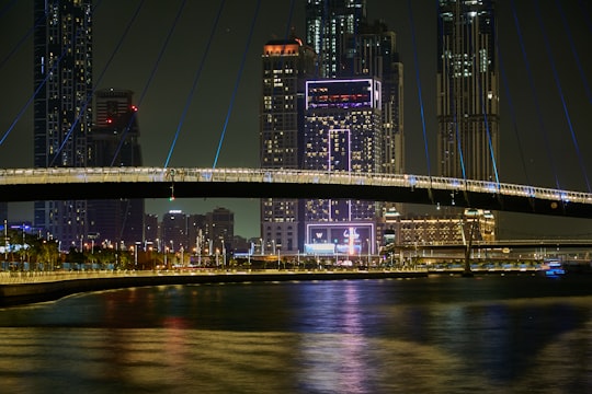 black suspension bridge during night time in Dubai Canal United Arab Emirates