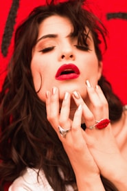 woman holding chin while closing both eyes