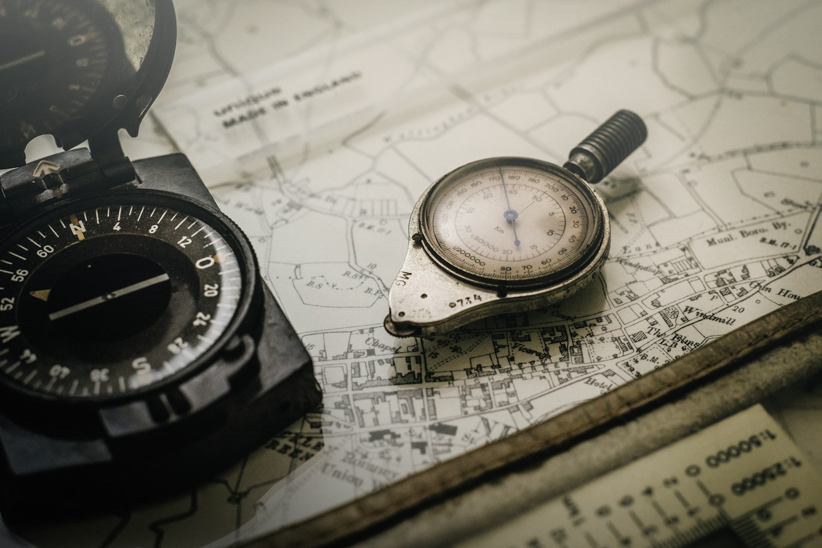 Black and gray compass resting on top of a map
