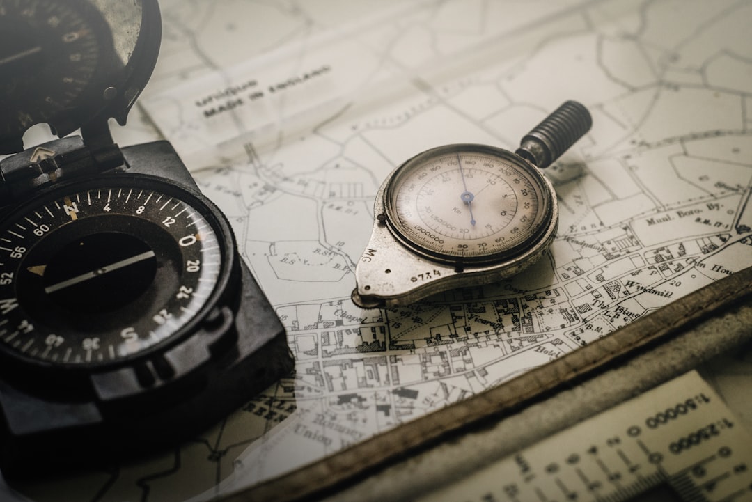 black and gray compass on top of map, map measure