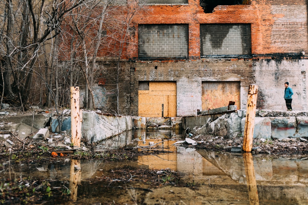 person standing beside concrete building