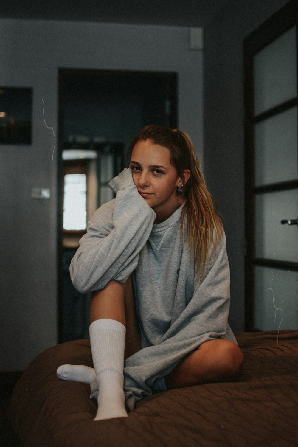 woman sitting on bed