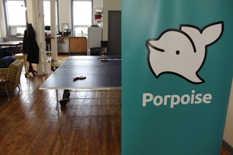 Portrait of Dolphin Kasper in a warm office setting, engaging thoughtfully with clients.