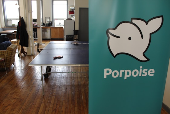 Portrait of Dolphin Kasper in a warm office setting, engaging thoughtfully with clients.