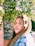 woman holding green leafed plant